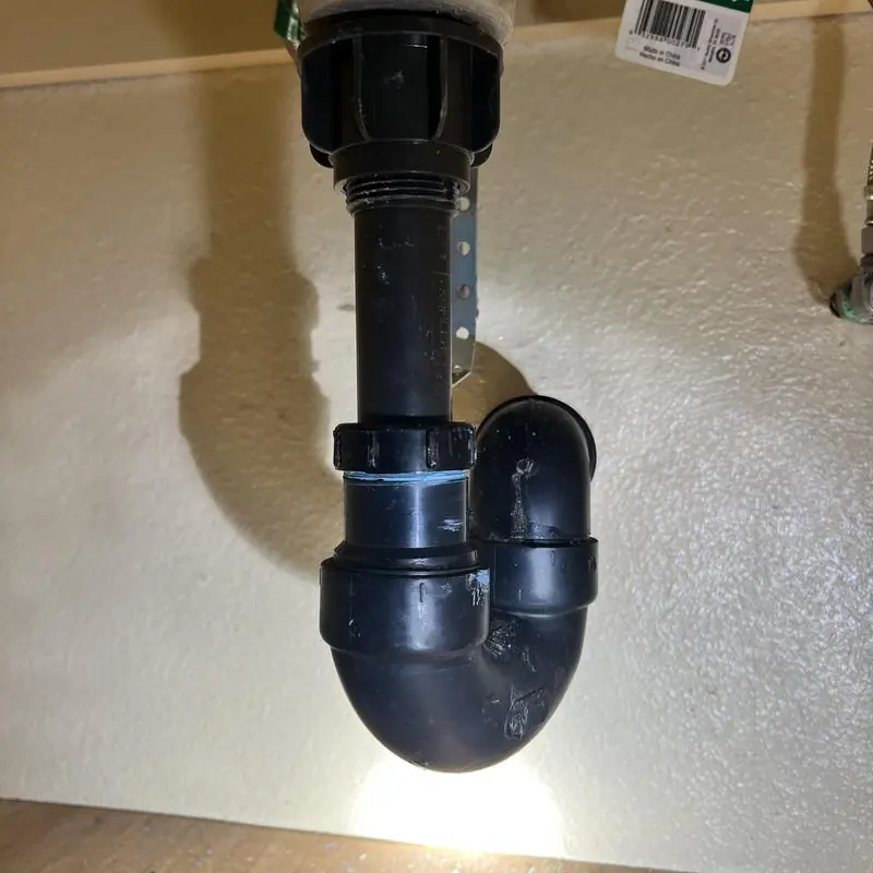 Pop-up drain assembly and plumbing under sink