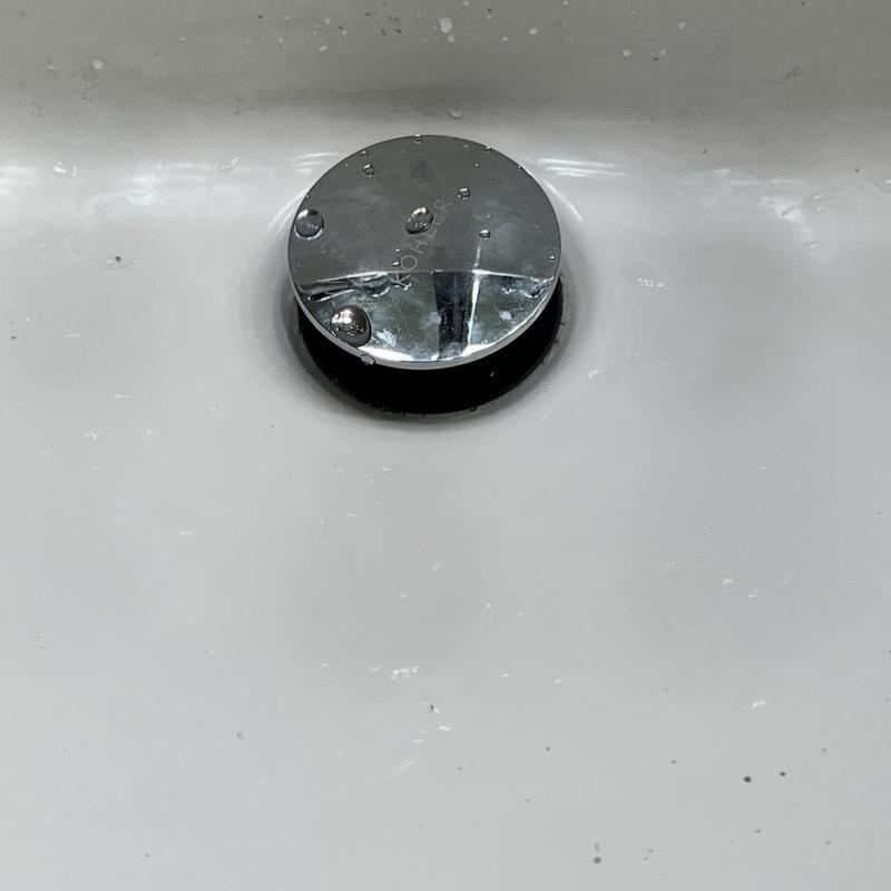 Bathroom sink Kohler pop-up drain assembly with water droplets