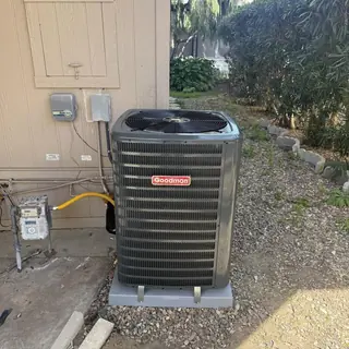 Goodman 3 ton condenser unit on new pad outdoors