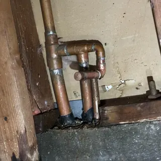 Copper water heater pipes with leak and reroute repair