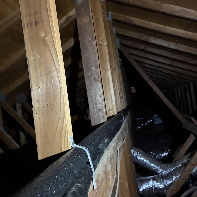 Hot water pipe reroute in attic with wood framing