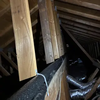 Hot water pipe reroute in attic with wood framing