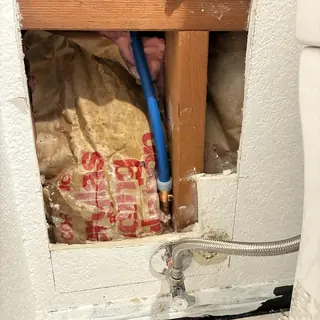 Hot water line reroute behind bathroom wall