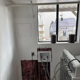 Hot and cold water lines reroute in laundry room wall