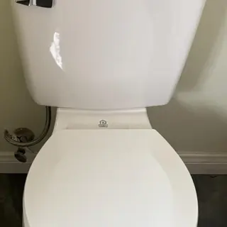 Toilet with 14-turn angle stop and stainless steel supply line