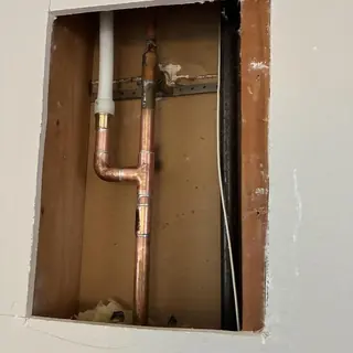 Copper hot water pipe reroute inside wall cavity