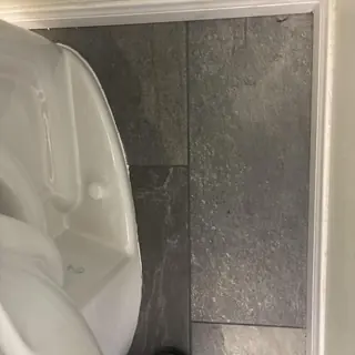 Elongated toilet installation with angle stop and supply line