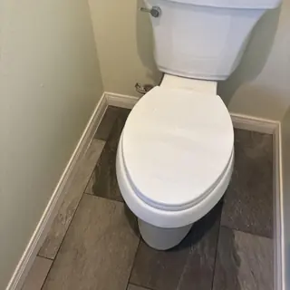 Elongated toilet with new angle stop and supply line