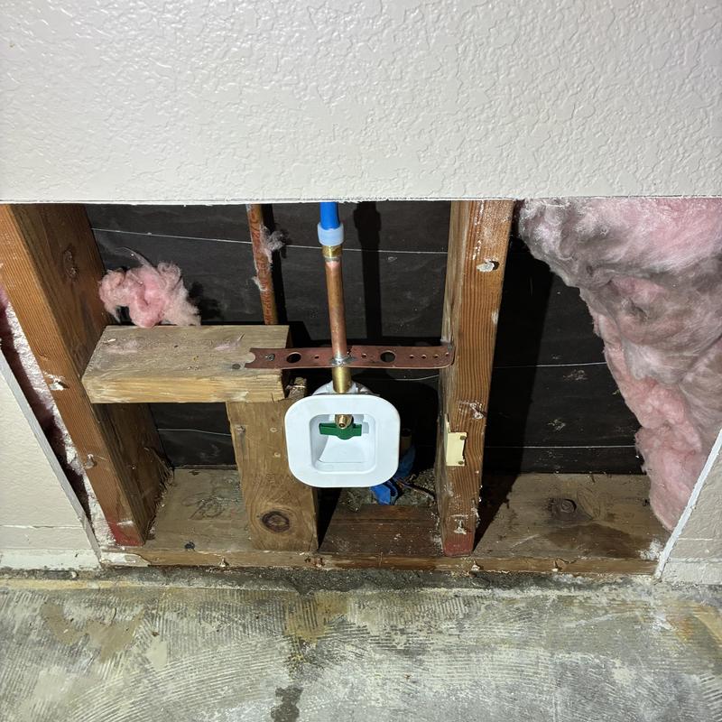 Ice maker water line reroute inside wall cavity
