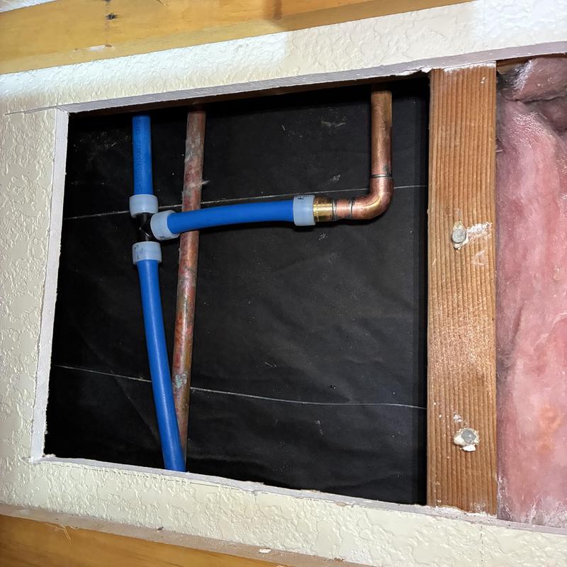 Cold water line reroute with copper and PEX pipes in wall