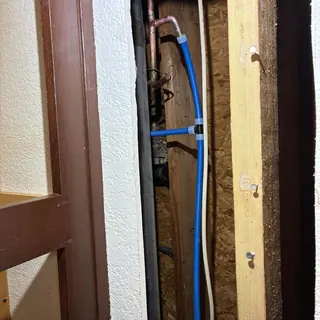 Completed cold-water line reroute behind a wall