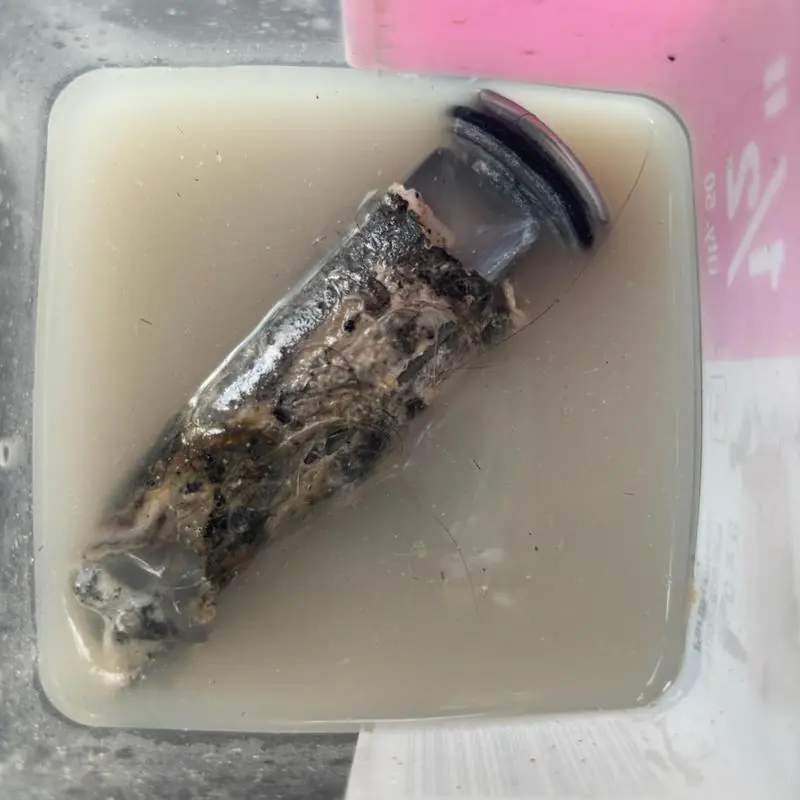 Bathroom sink pop-up assembly clogged with gunk and hair