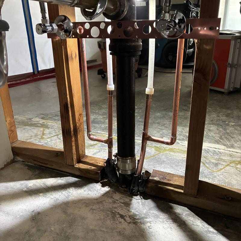 Copper cold water pipes installation under sink framing