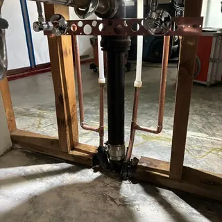 Copper cold water pipes installation under sink framing