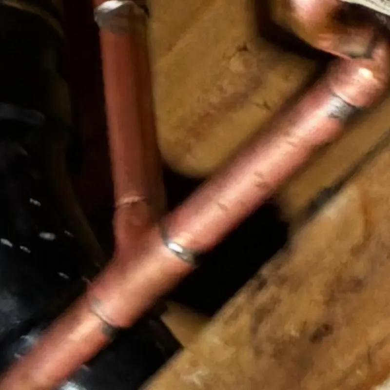 Copper water pipes with ceiling insulation surrounding