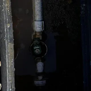 Water main valve with leaking pipe in wet ground