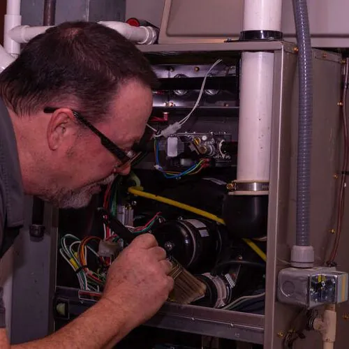 Technician makes emergency furnace repair.